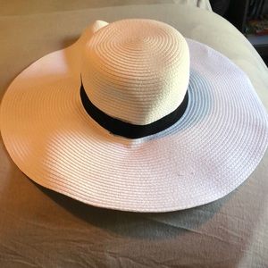 white sun hat with black ribbon